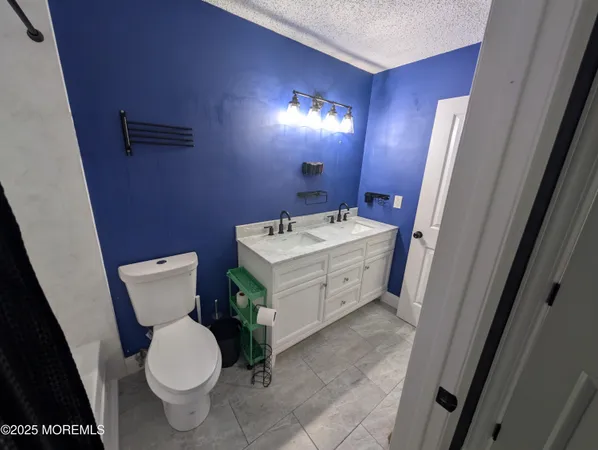 a bathroom with a sink toilet and mirror