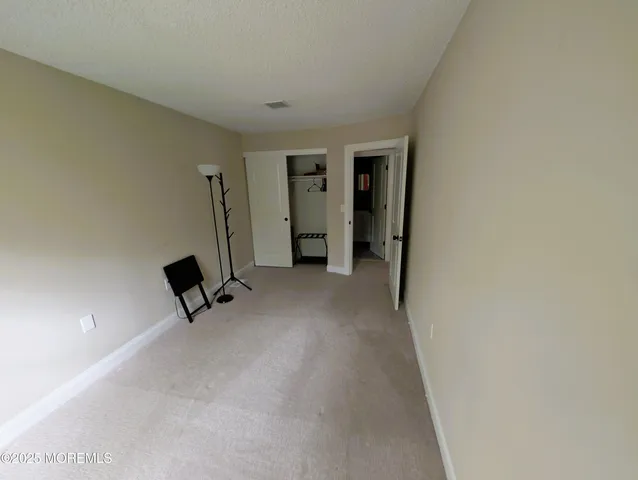 a view of a livingroom with a chair and a ceiling fan