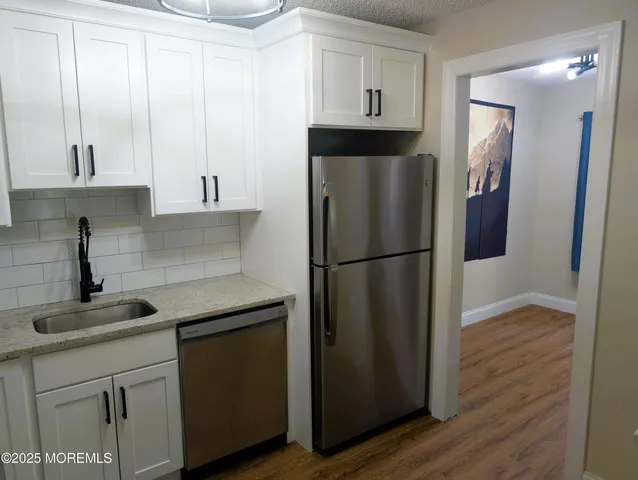 a kitchen with a refrigerator and cabinets