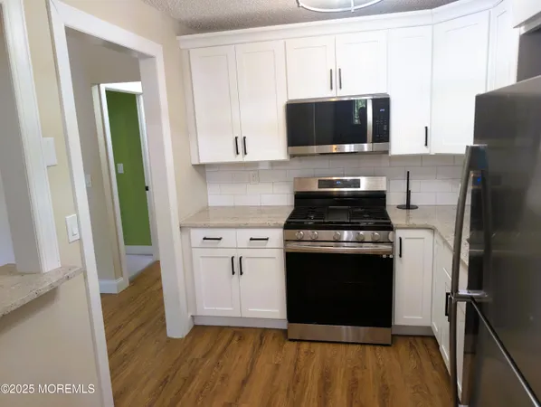a kitchen with a stove and a microwave