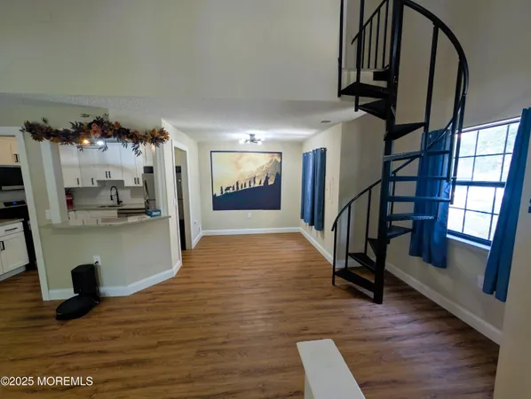 a view of entryway and hall with wooden floor