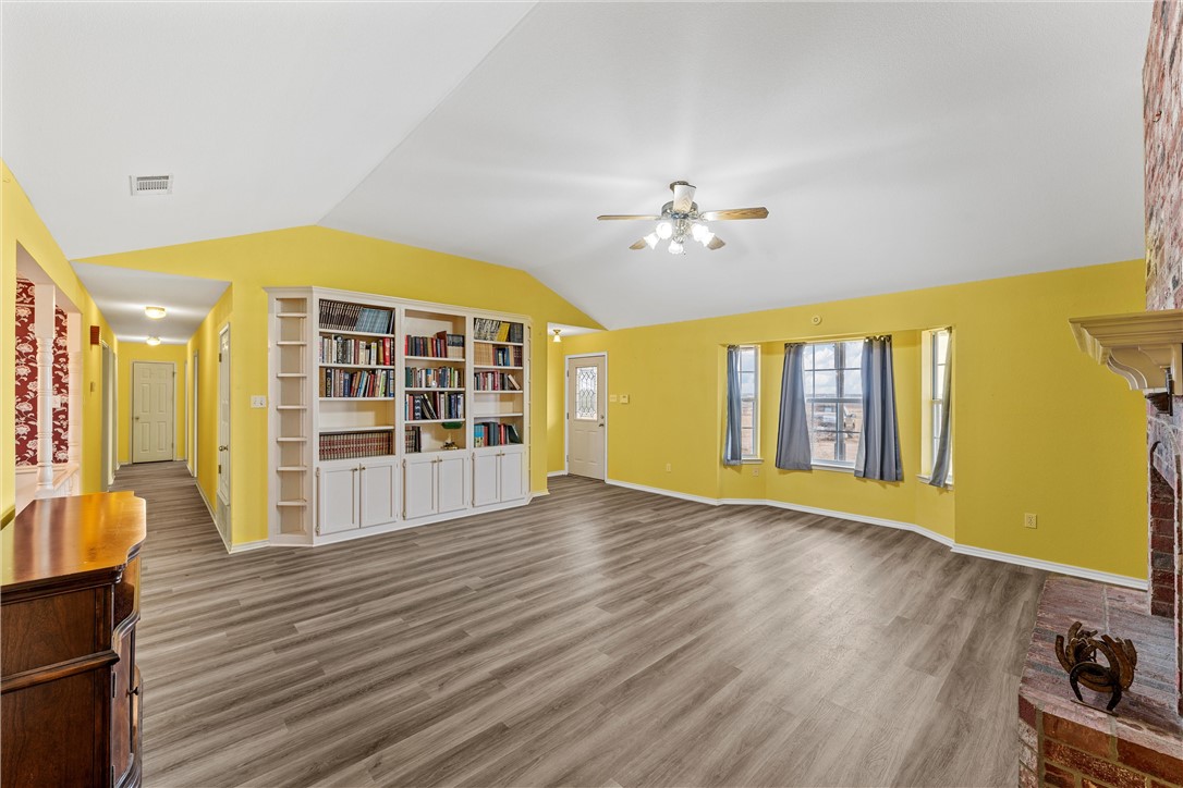 807 Birdie Lane Lorena, TX 76655 - Photo 5 of 32 a view of an empty room with window and wooden floor
