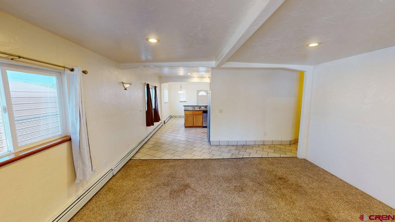 807 13th Street Alamosa, CO 81101 - Photo 11 of 31 a view of a hallway with wooden floor and a window