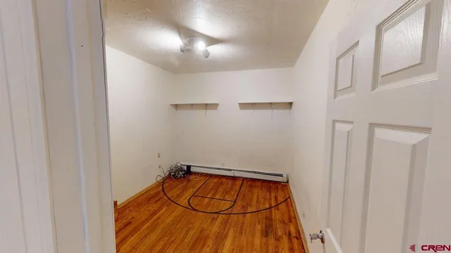 a view of a room with wooden floor