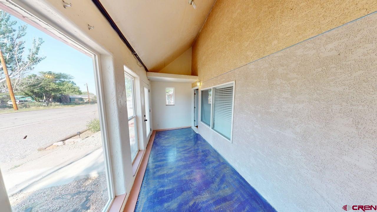 807 13th Street Alamosa, CO 81101 - Photo 2 of 31 a view of a hallway with wooden floor and staircase