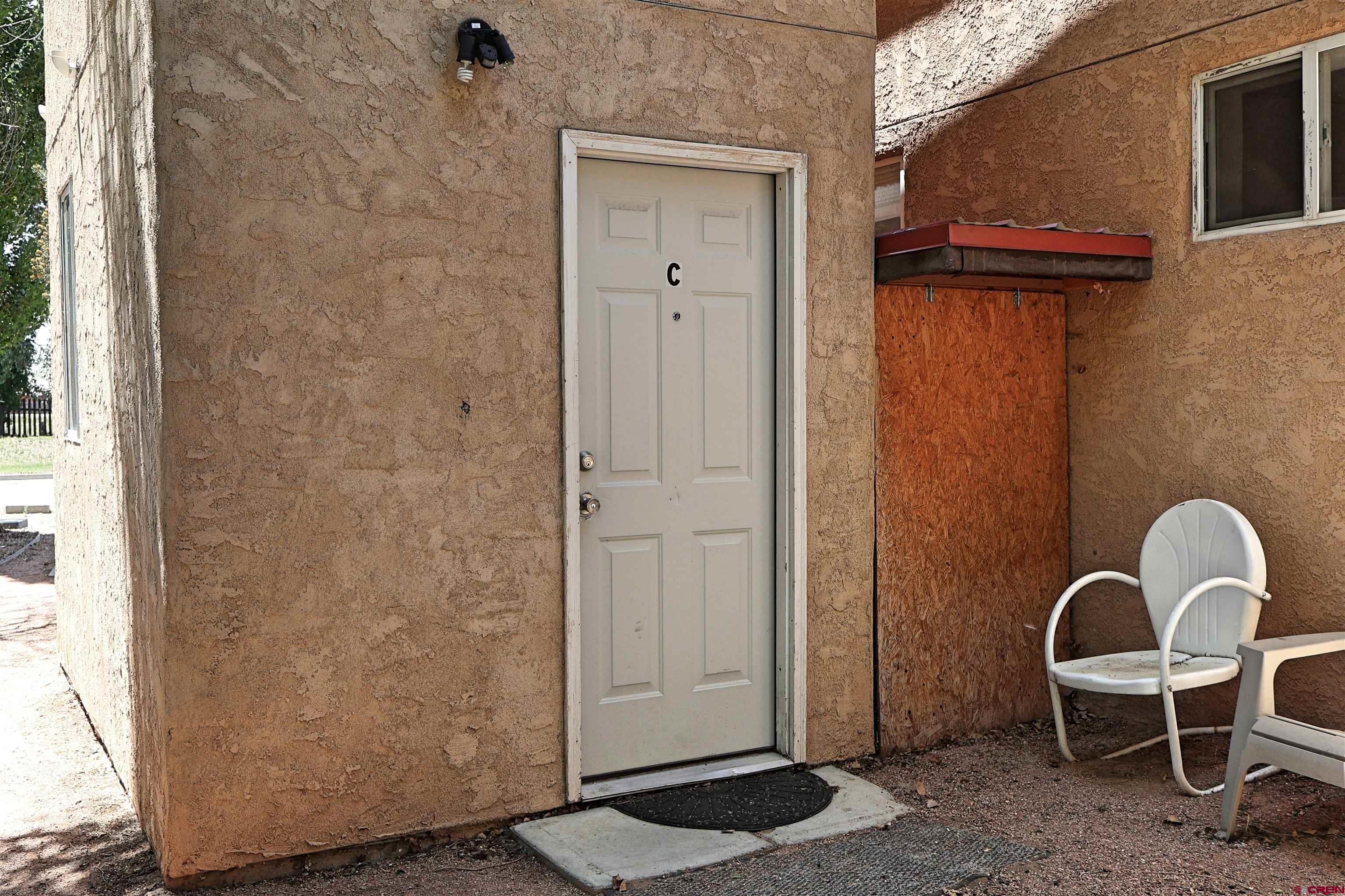 807 13th Street Alamosa, CO 81101 - Photo 25 of 31 a view of a door and chair in the room