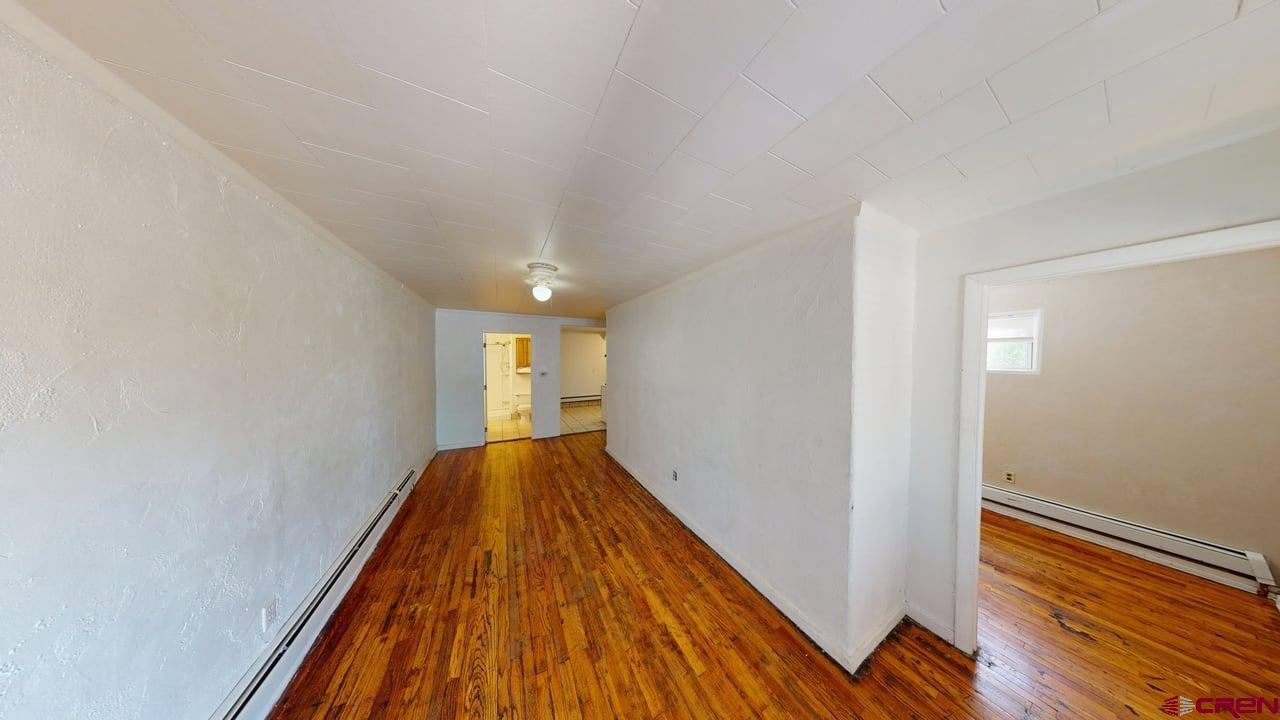 807 13th Street Alamosa, CO 81101 - Photo 4 of 31 a view of a room with wooden floor