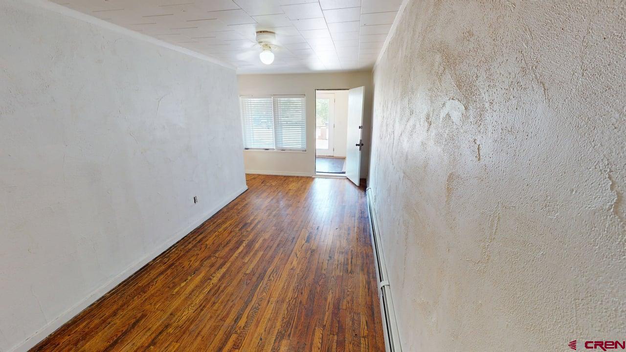 807 13th Street Alamosa, CO 81101 - Photo 5 of 31 a view of a room with wooden floor and window