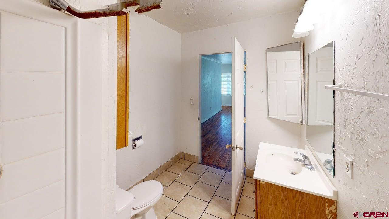 807 13th Street Alamosa, CO 81101 - Photo 9 of 31 a bathroom with a bathtub and a sink