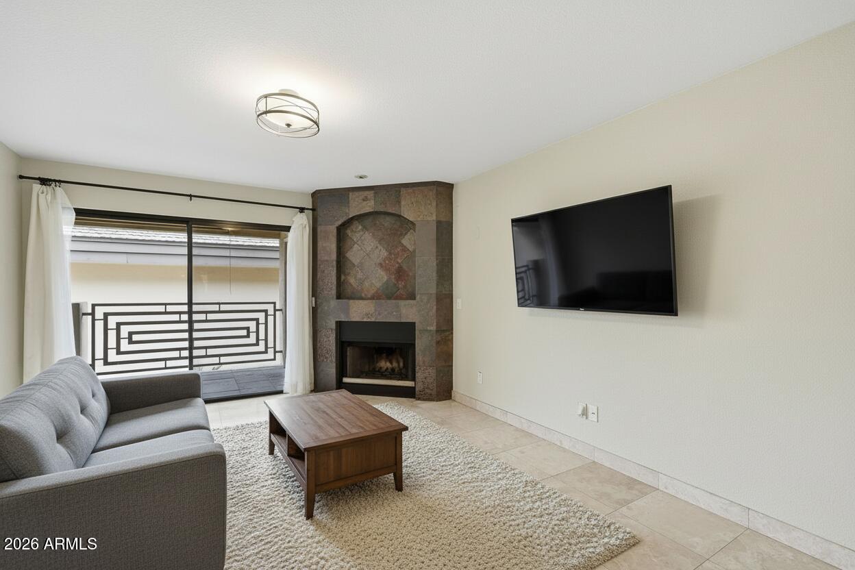 3235 East Camelback Road, Unit 211 Phoenix, AZ 85018 - Photo 7 of 17 a living room with furniture and a flat screen tv