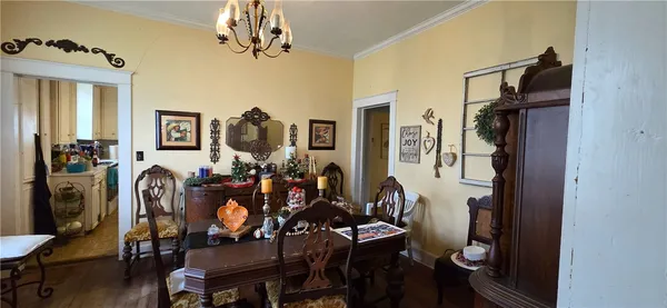 a view of a dining room with furniture and chandelier
