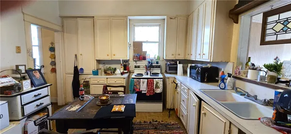 a kitchen with a sink stove and cabinets