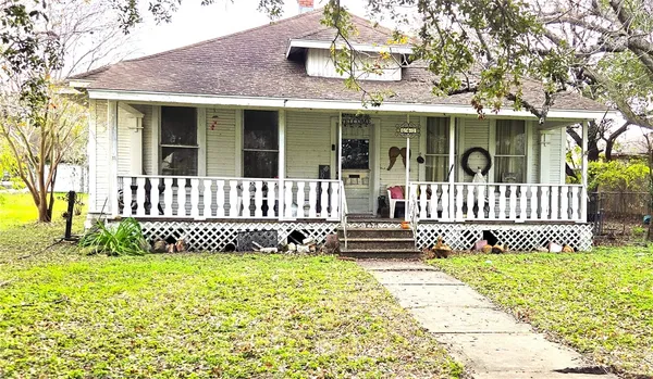 a front view of a house with a garden and deck