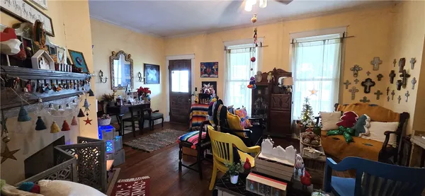 a living room filled with furniture and a potted plant