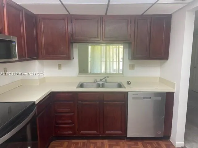 a kitchen with a sink cabinets and window