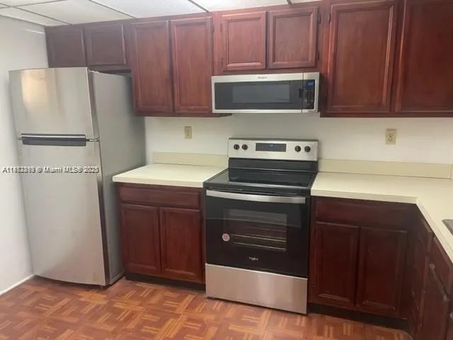 a kitchen with a refrigerator and a stove