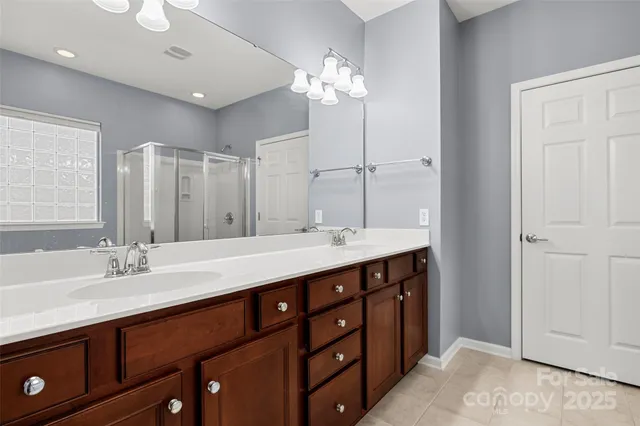 a bathroom with a double vanity sink and a mirror