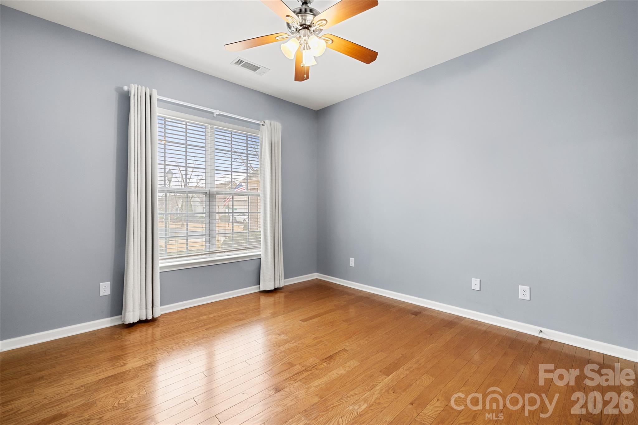 52538 Winchester Street Fort Mill, SC 29707 - Photo 18 of 48 an empty room with a window and a ceiling fan