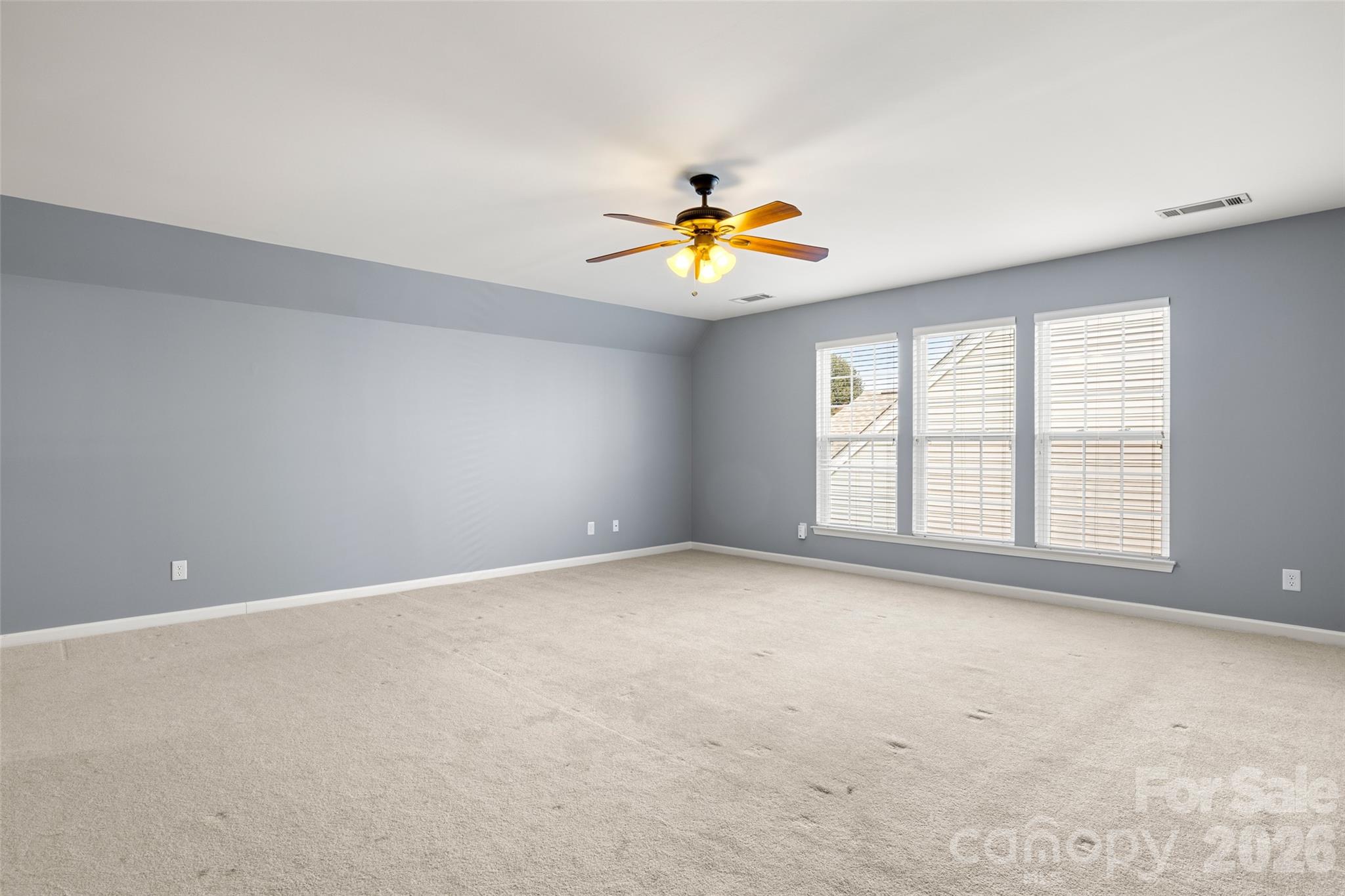 52538 Winchester Street Fort Mill, SC 29707 - Photo 21 of 48 an empty room with a window and a ceiling fan