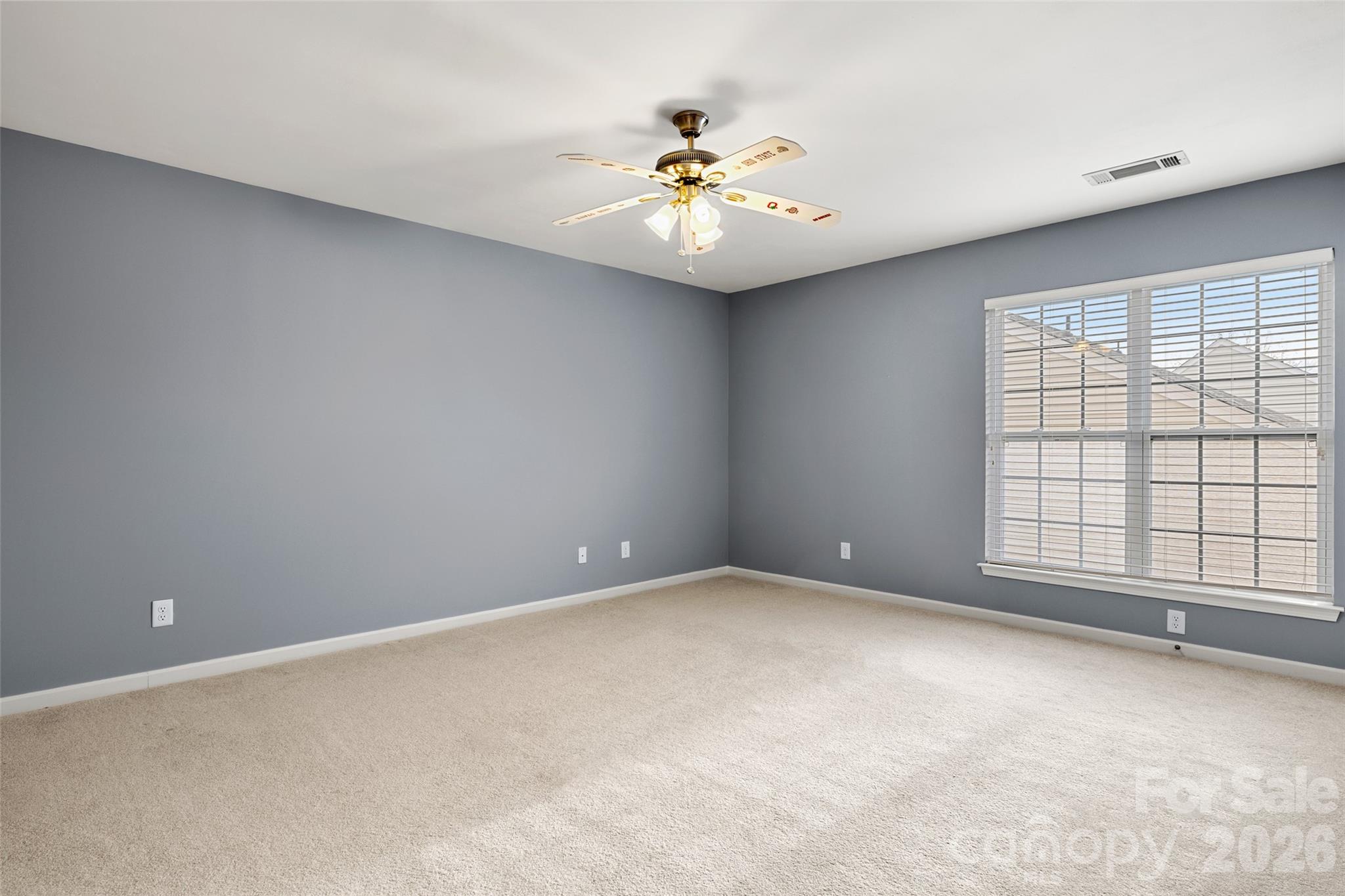 52538 Winchester Street Fort Mill, SC 29707 - Photo 23 of 48 an empty room with chandelier fan and windows