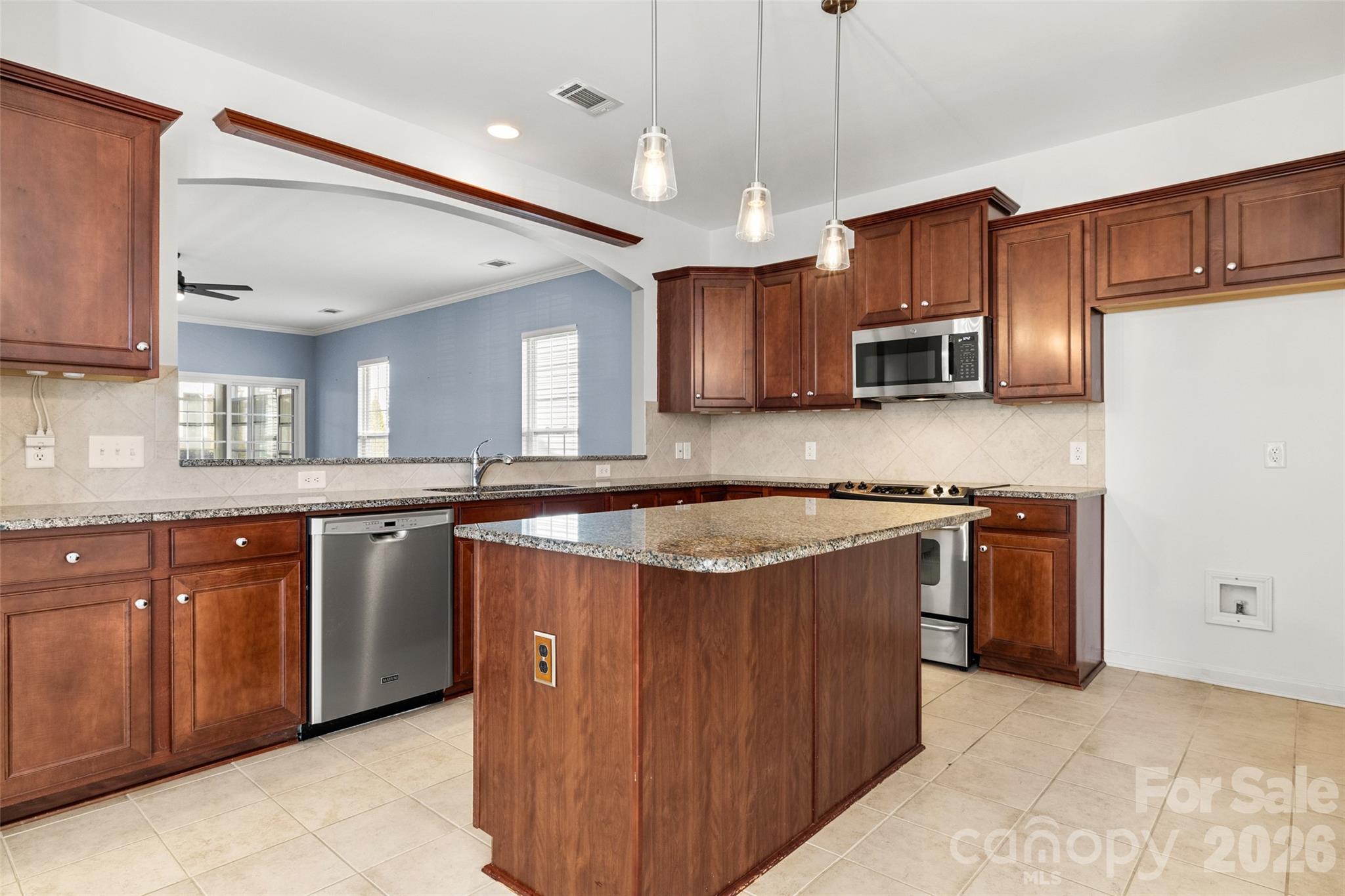 52538 Winchester Street Fort Mill, SC 29707 - Photo 7 of 48 a large kitchen with stainless steel appliances granite countertop a sink a stove a refrigerator and island