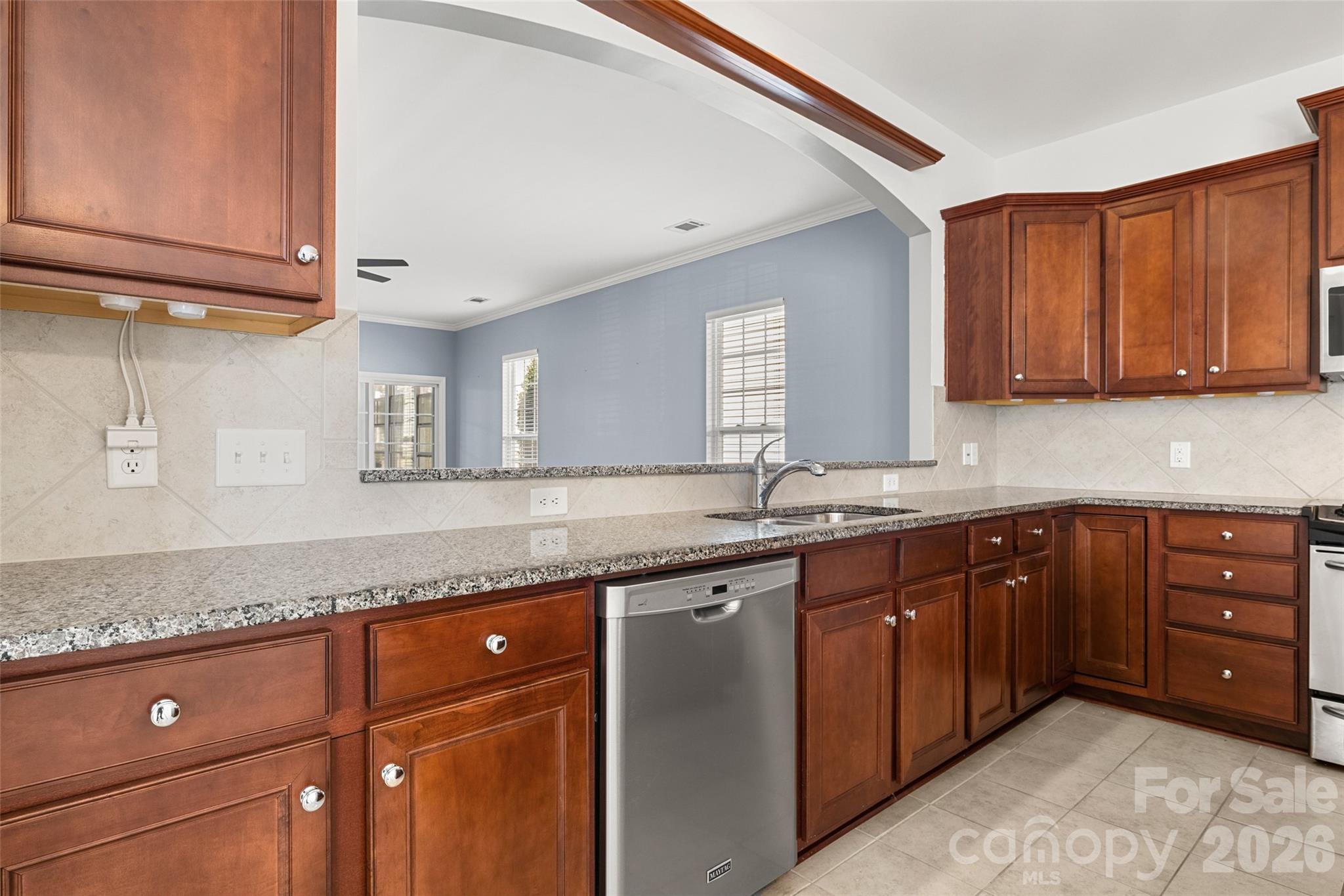 52538 Winchester Street Fort Mill, SC 29707 - Photo 8 of 48 a kitchen with granite countertop wooden cabinets and a sink