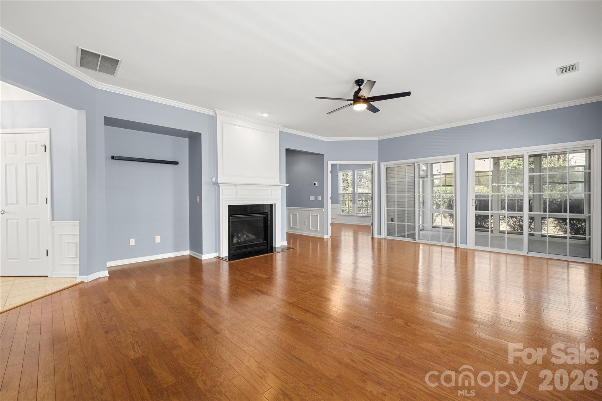 52538 Winchester Street Fort Mill, SC 29707 - Photo 9 of 48 an empty room with floor to ceiling windows and a fireplace