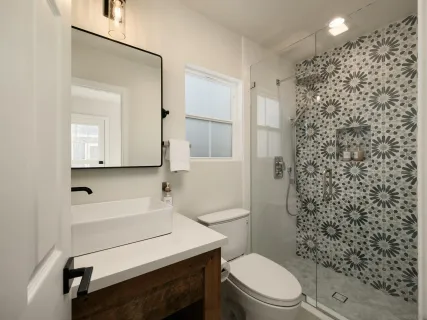 a bathroom with a sink a toilet and shower