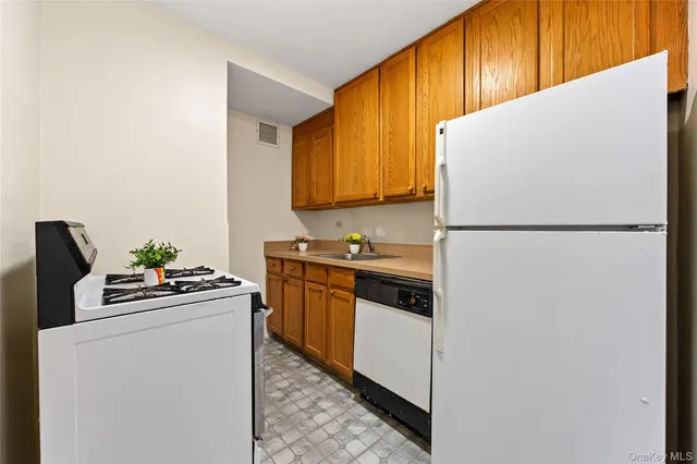 a kitchen with a refrigerator sink stove and cabinets