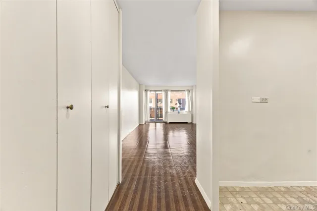 a view of a hallway with wooden floor