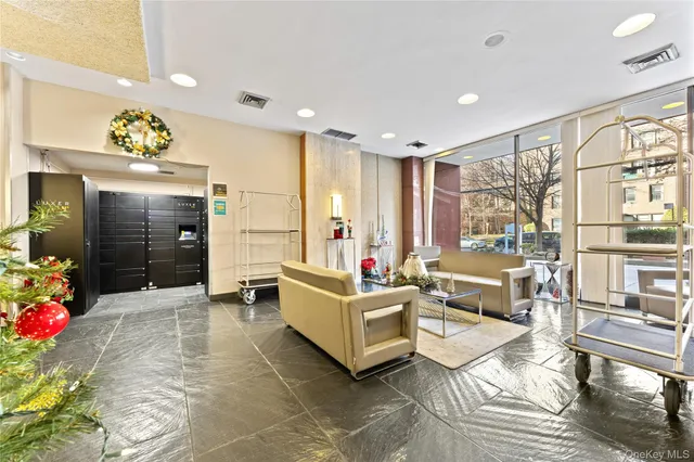 a living room with furniture and a chandelier