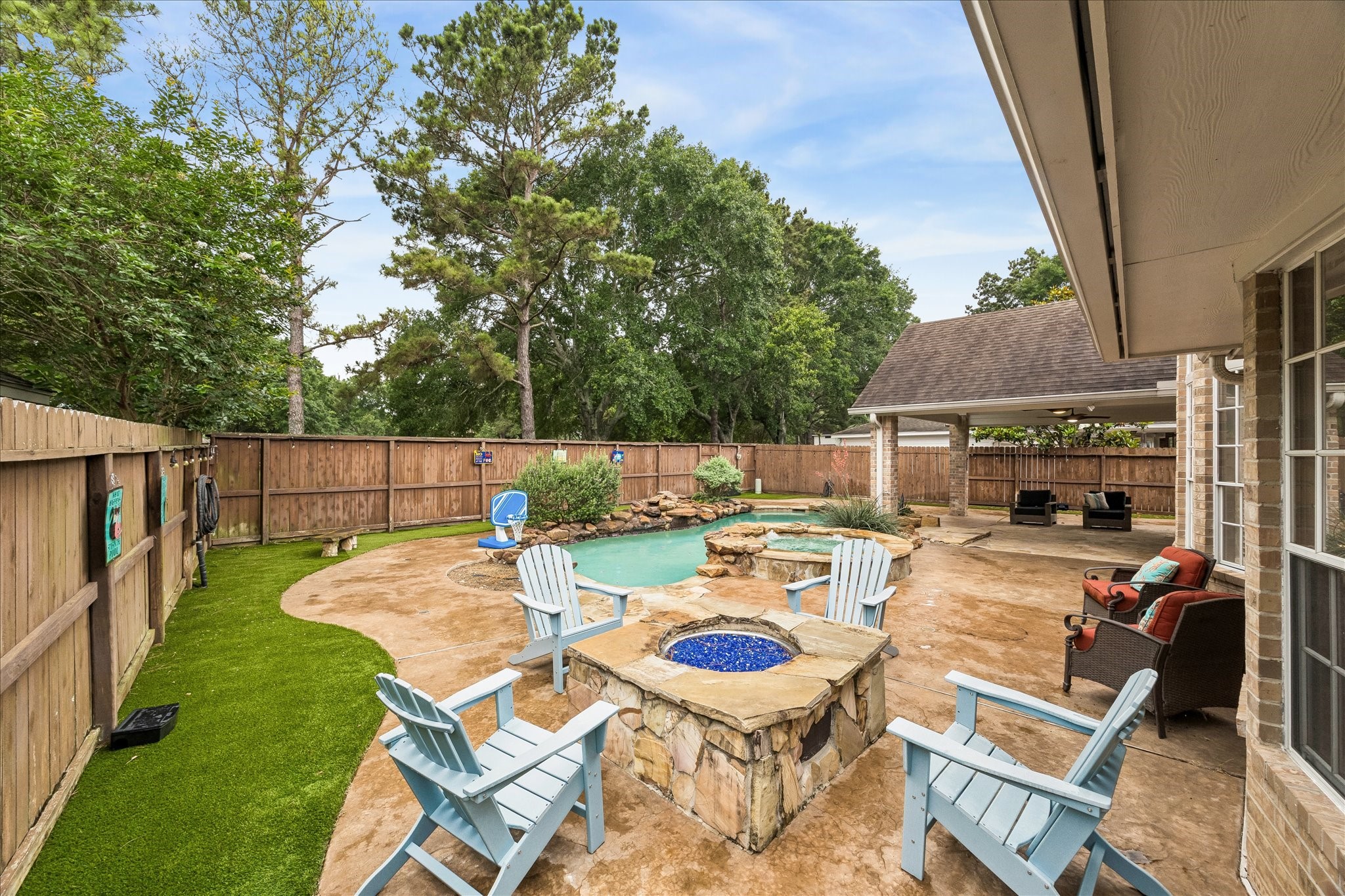 23039 Enchanted Landing Lane Katy, TX 77494 - Photo 30 of 30 a view of a patio with table and chairs potted plants and a palm tree