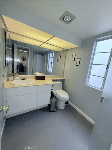 a bathroom with a sink mirror and toilet