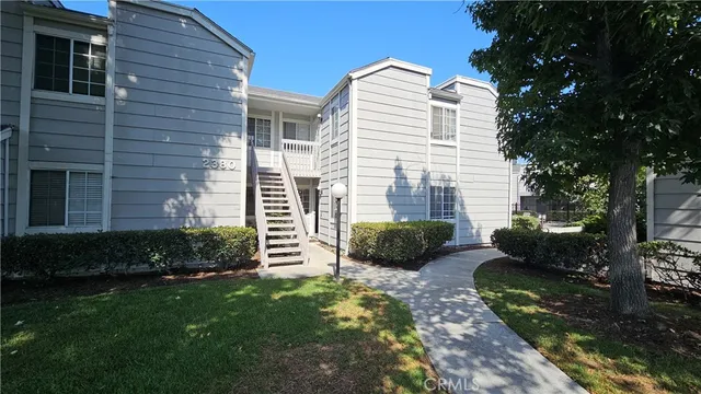 a view of a house with a yard and a garden