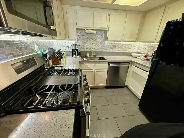 a kitchen with a stove a sink and a microwave