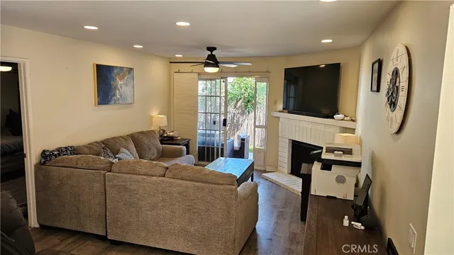a living room with furniture a fireplace and a flat screen tv