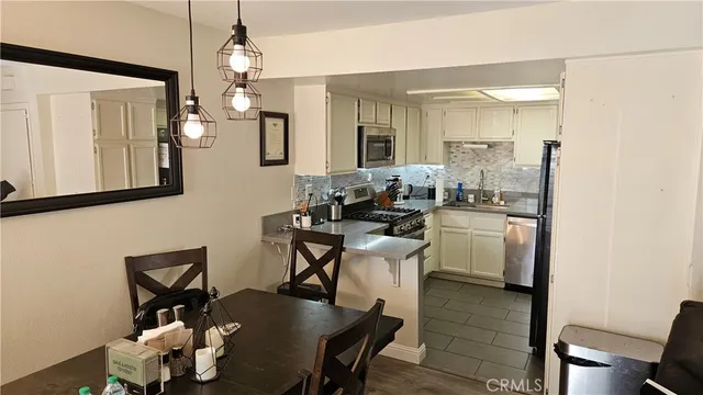 a dining room with furniture and wooden floor