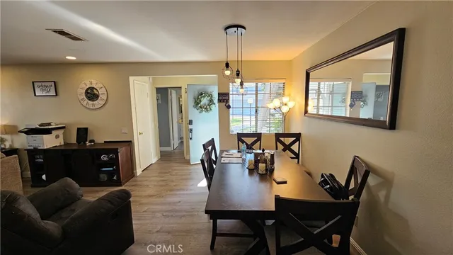 a view of a dining room with furniture and window