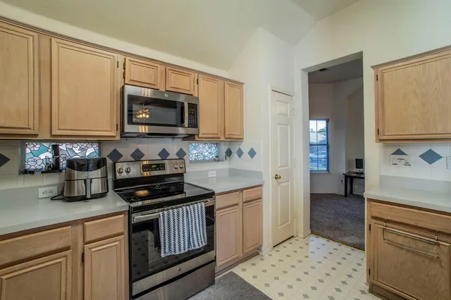 a kitchen with a sink stove and cabinets