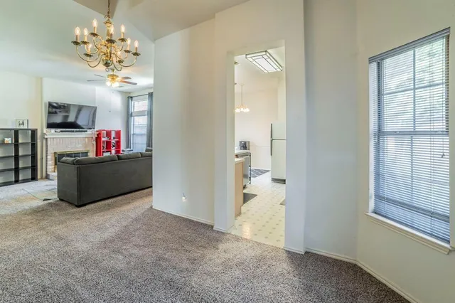 a living room with kitchen island furniture and a chandelier