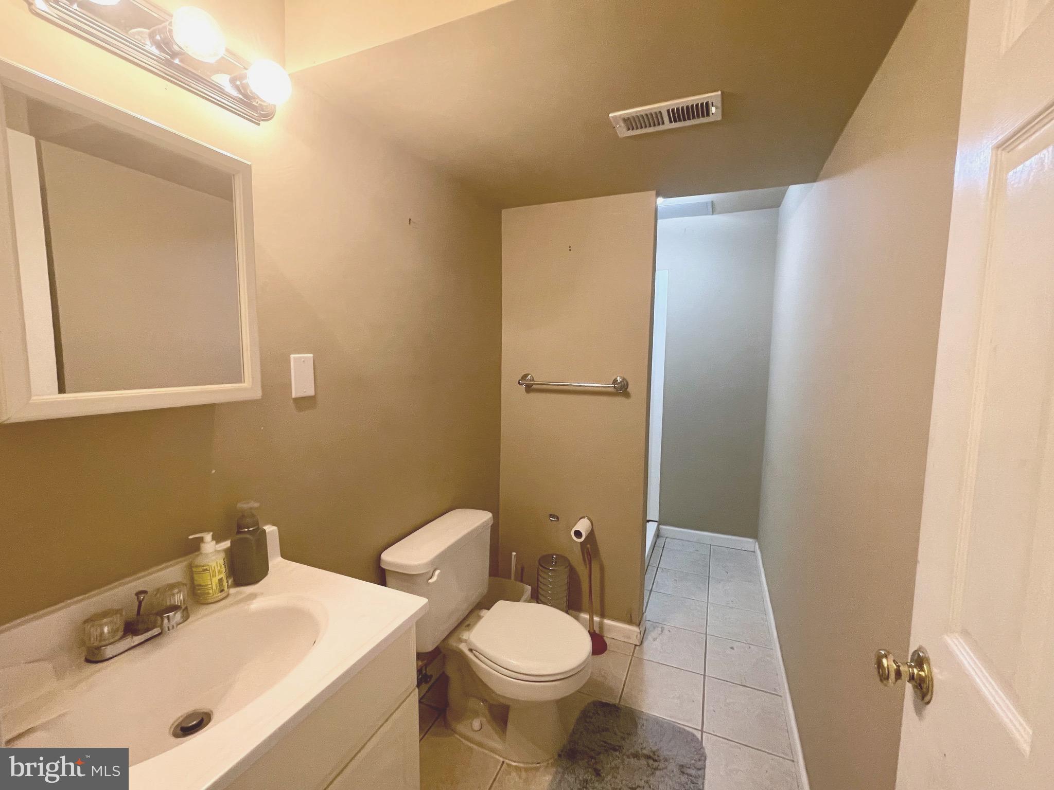 12125 Stoney Bottom Road Germantown, MD 20874 - Photo 19 of 23 a bathroom with a sink toilet and shower