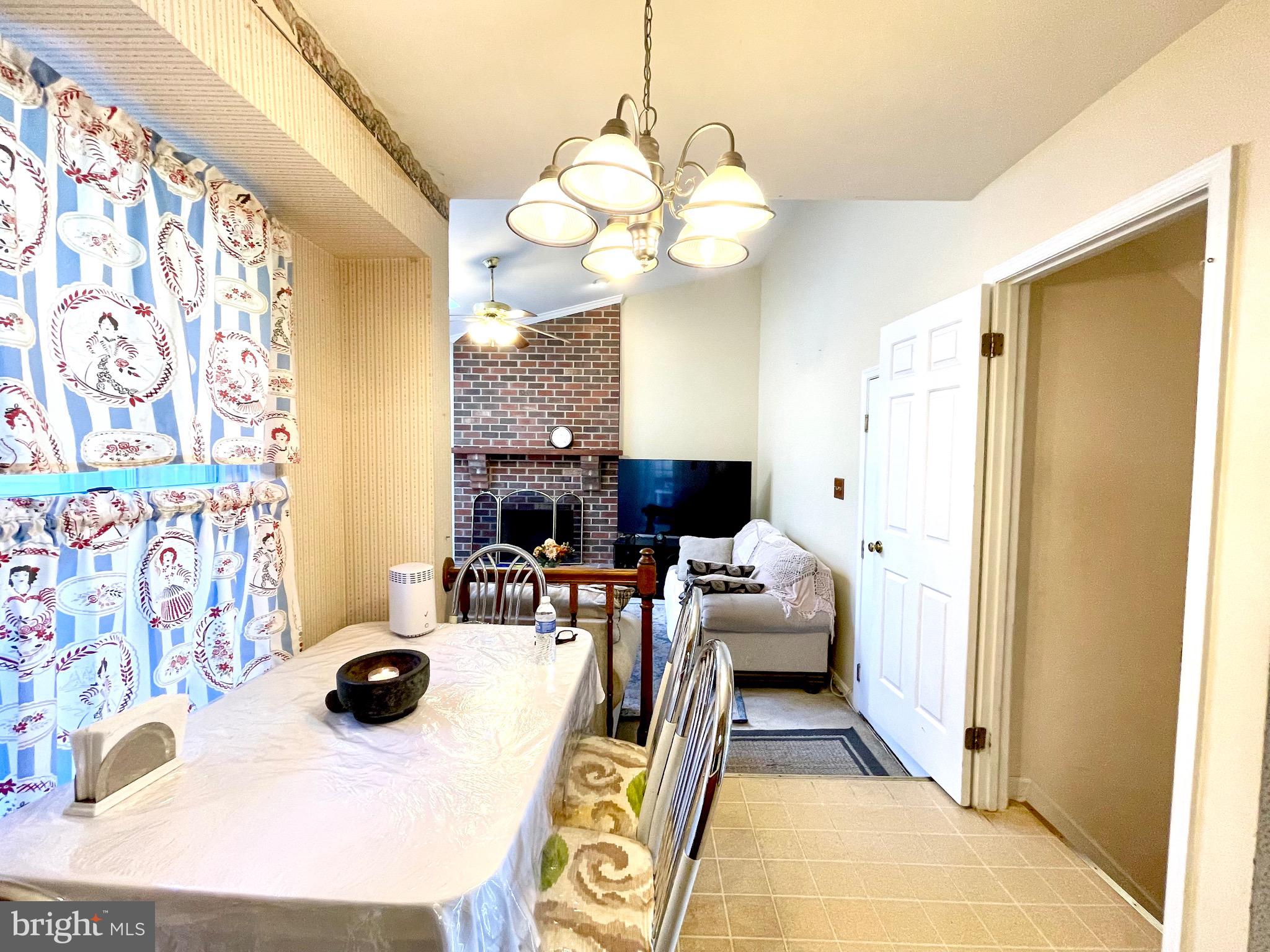 12125 Stoney Bottom Road Germantown, MD 20874 - Photo 9 of 23 a living room with furniture and a chandelier