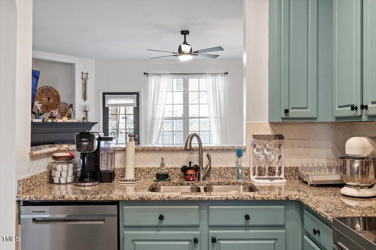 5730 Clearbay Lane Raleigh, NC 27612 - Photo 12 of 32 a kitchen with granite countertop stainless steel appliances sink stove and cabinets