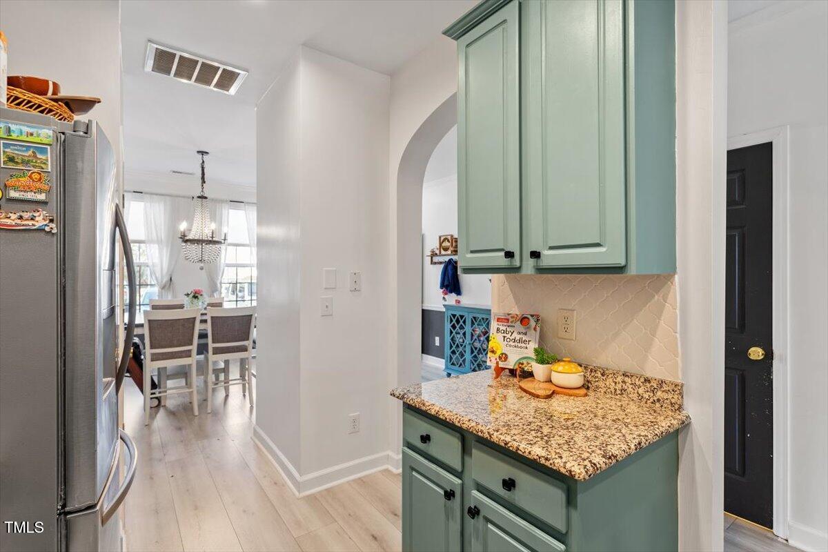 5730 Clearbay Lane Raleigh, NC 27612 - Photo 14 of 32 a kitchen with stainless steel appliances granite countertop a sink and a refrigerator