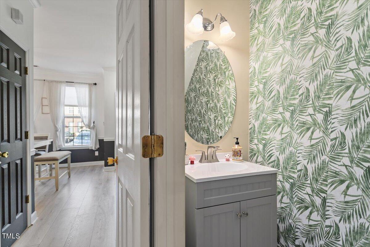 5730 Clearbay Lane Raleigh, NC 27612 - Photo 16 of 32 a bathroom with a sink and a mirror