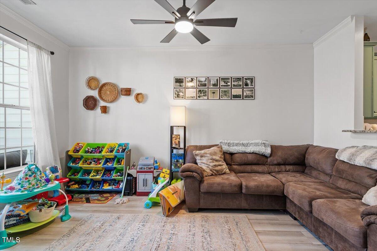 5730 Clearbay Lane Raleigh, NC 27612 - Photo 19 of 32 a living room with painting on the wall and a window
