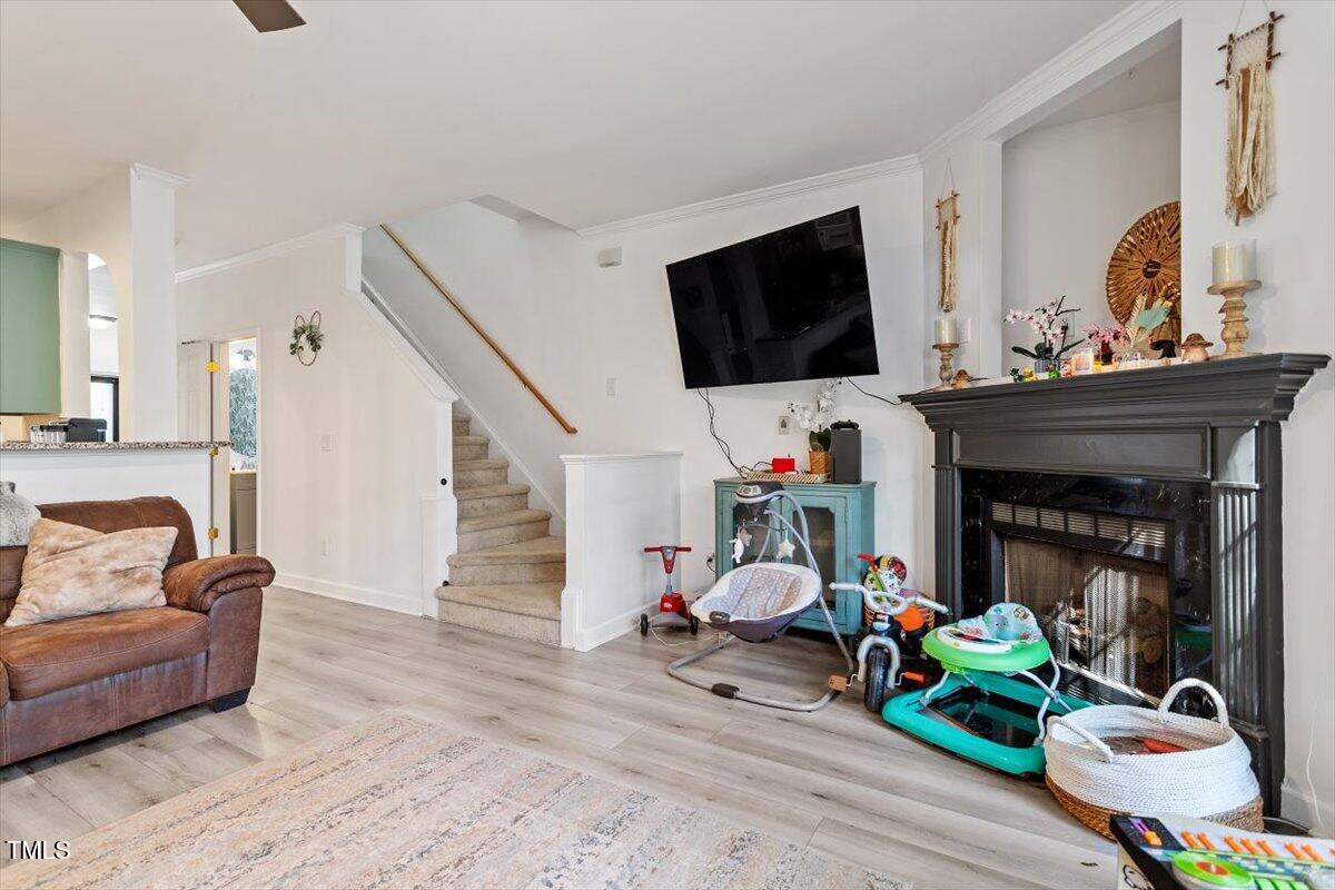 5730 Clearbay Lane Raleigh, NC 27612 - Photo 21 of 32 a living room with furniture and a flat screen tv