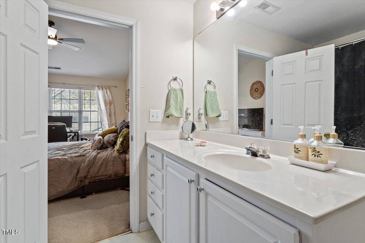 5730 Clearbay Lane Raleigh, NC 27612 - Photo 25 of 32 a en suite bathroom with double vanity and a mirror