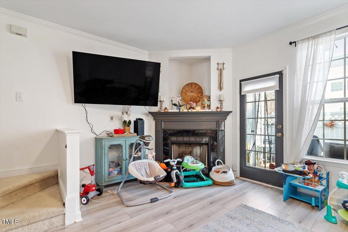 5730 Clearbay Lane Raleigh, NC 27612 - Photo 26 of 32 a living room with furniture and a fireplace
