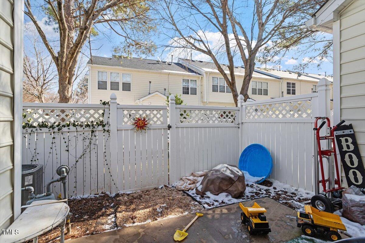 5730 Clearbay Lane Raleigh, NC 27612 - Photo 31 of 32 a backyard of a house with table and chairs